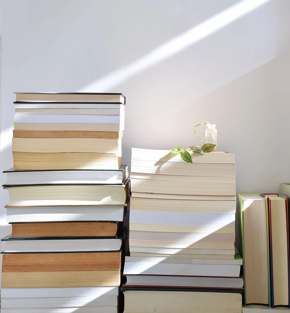 filtered sunlight shining on stacks of books
